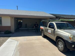 A technician from Central Garage Door Repair LLC arriving at a residential property for garage door service in Glendale, AZ.