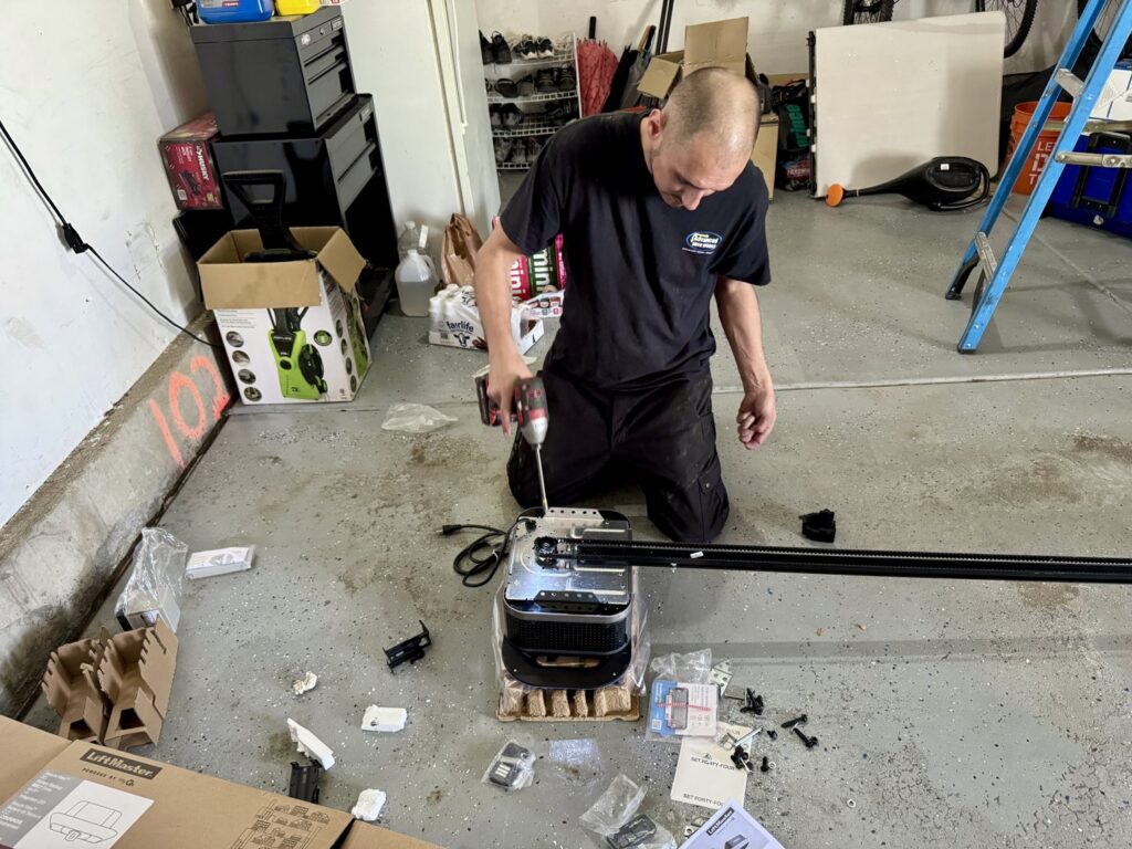A technician assembling a new garage door opener for Advanced Door Works in Highlands Ranch, CO