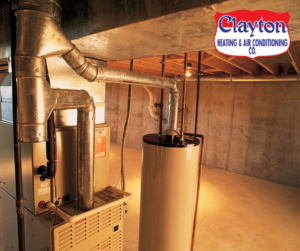 A technician changing a dirty air filter in an HVAC system for Clayton Heating & Air Conditioning Co. in Youngstown, OH.