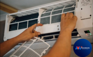 A technician's hands changing an air filter in an indoor HVAC unit, a service provided by My Mechanical Heating and Cooling in Lancaster, PA