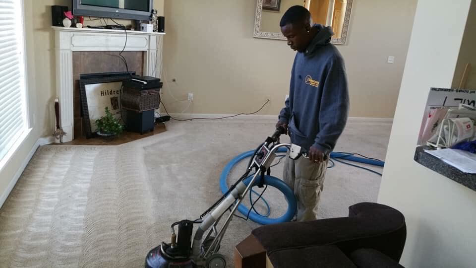 A technician operating a professional carpet cleaning machine for FABULOUS CARPET CARE in Memphis, TN.