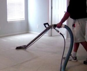 A technician operating a professional carpet cleaning machine in a room, provided by Superior Carpet Cleaning in Greenville, SC.