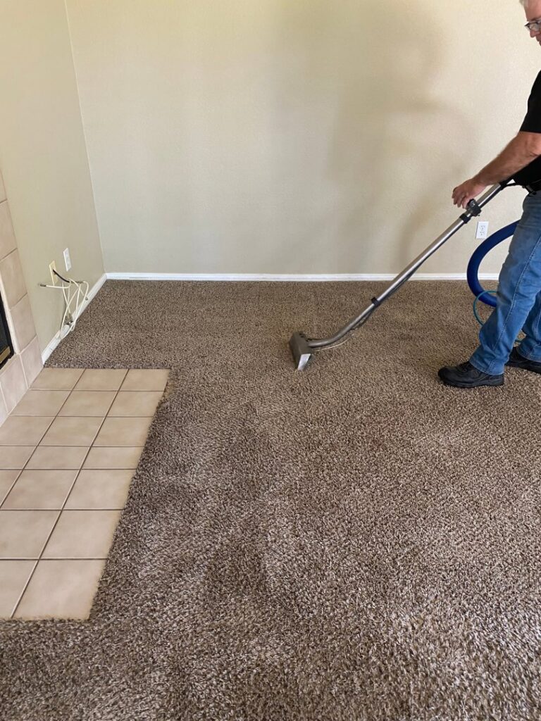 A technician from Raysco, Inc. using a cleaning wand to deep clean a carpet in Las Vegas, NV.