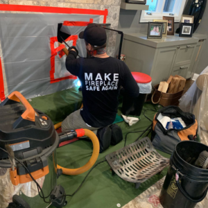 A technician from Dryer Vent Pro cleaning a fireplace, ensuring safety in a Chicago, IL home.