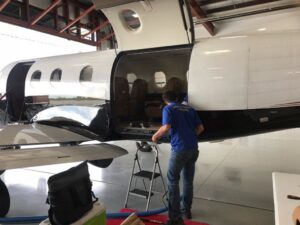 A Mark's Carpet Cleaning technician cleaning the interior of a private jet in Omaha, NE
