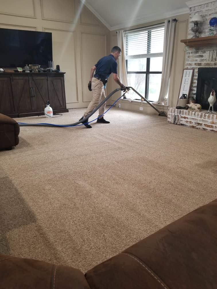 A SAENZ Carpet Cleaning technician professionally cleaning a residential carpet in Dallas, TX.