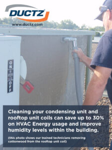 A technician cleaning a rooftop HVAC condensing unit coil for Ductz of Southeast Michigan in Livonia, MI.