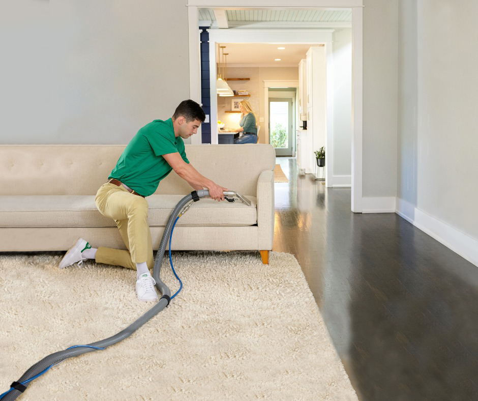 A technician cleaning a sofa and rug with professional equipment for Mountainview Chem-Dry in Birmingham, AL.