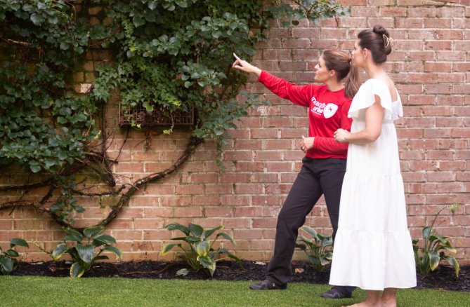 A Mosquito Shield of Savannah technician consulting with a client about pest control in Savannah, GA.