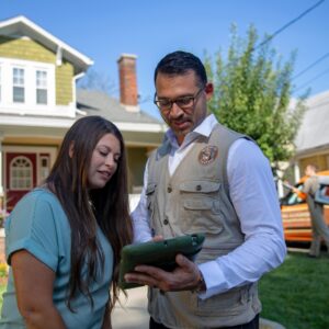 A Mosquito Hunters of Austin - Round Rock - Pflugerville technician consulting with a client about pest control services in Austin, TX.