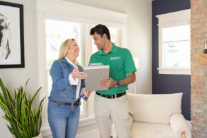 A Brimley's White Glove Chem-Dry technician consults with a client in a home in Mesa, AZ.