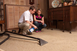 A carpet cleaning technician discussing carpet condition with a customer at DanCare Carpet Cleaning in Albuquerque, NM