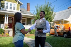 A Mosquito Hunters of Layton-Kaysville-Farmington technician shaking hands with a customer in Layton, UT.