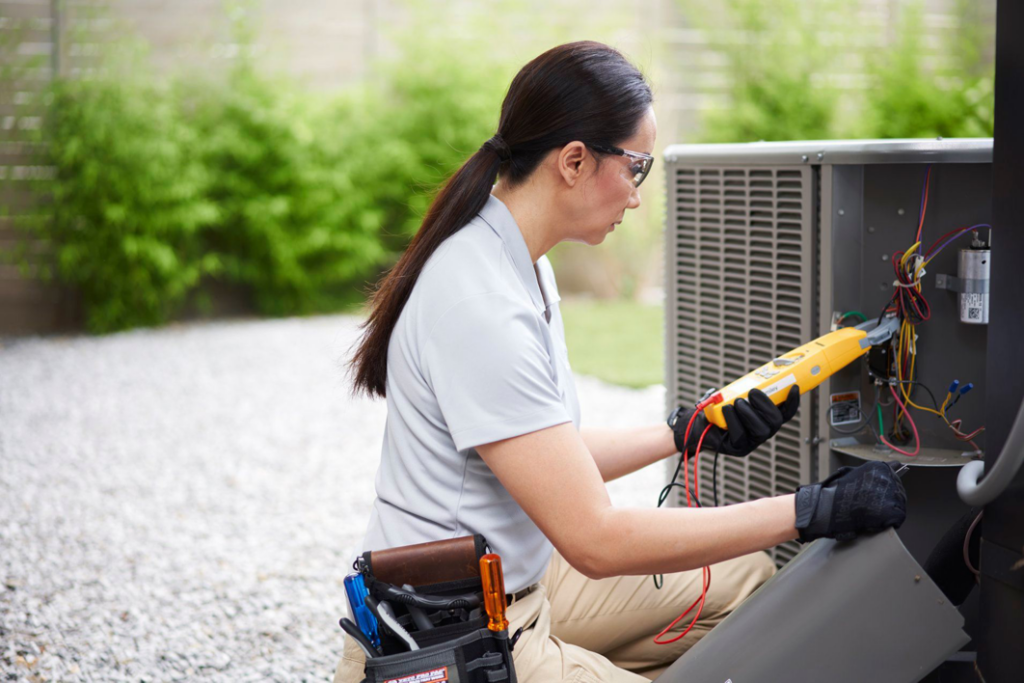 A Venti Heating and Cooling technician diagnosing an outdoor AC unit in Indianapolis, IN.