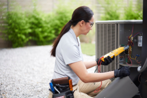 A Venti Heating and Cooling technician diagnosing an outdoor AC unit in Indianapolis, IN.