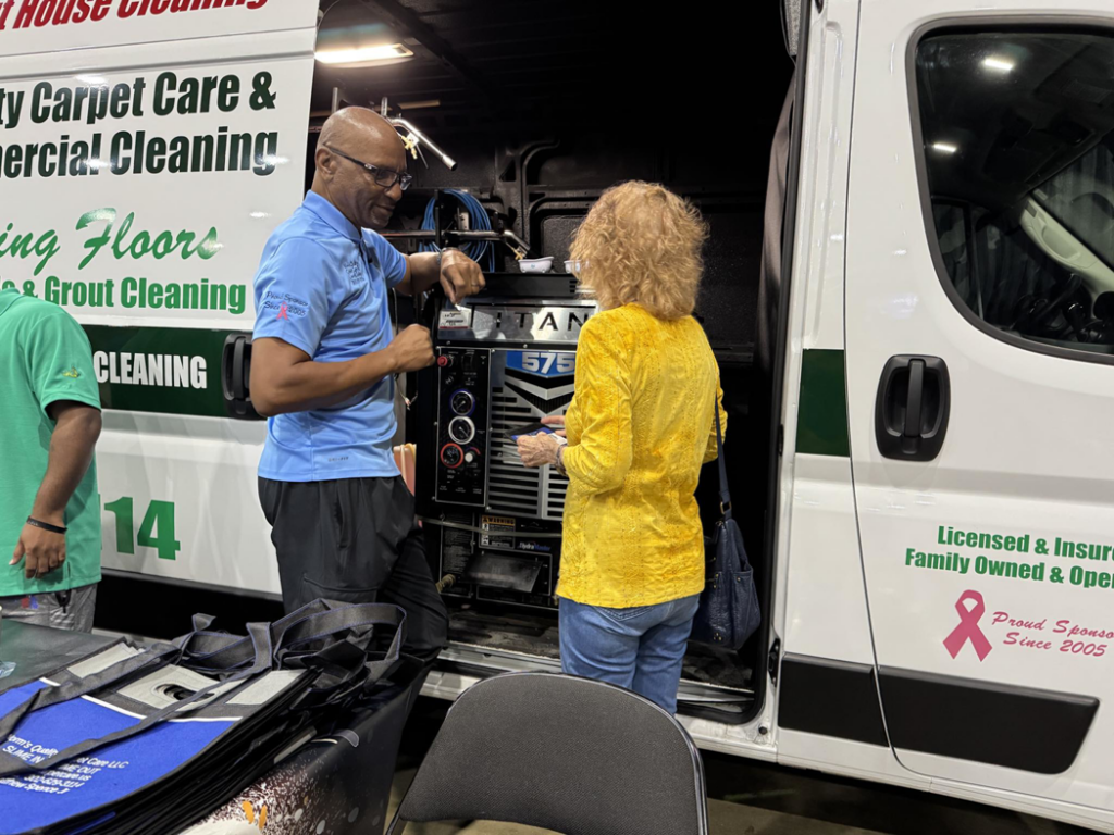 A technician from Worm's Quality Carpet Care & Commercial Cleaning, LLC discussing services with a client in Seaford, DE.