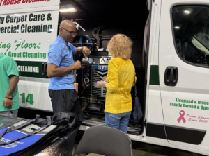 A technician from Worm's Quality Carpet Care & Commercial Cleaning, LLC discussing services with a client in Seaford, DE.
