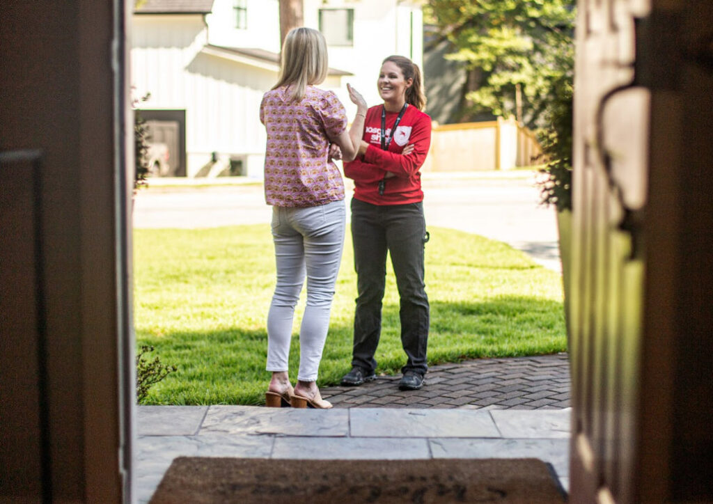 A Mosquito Shield of Savannah technician discussing pest control service with a client at their home in Savannah, GA.