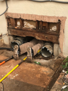A technician performing ductwork repair in a crawl space for ALL YEAR Heating, Air and Solar in Sacramento, CA.