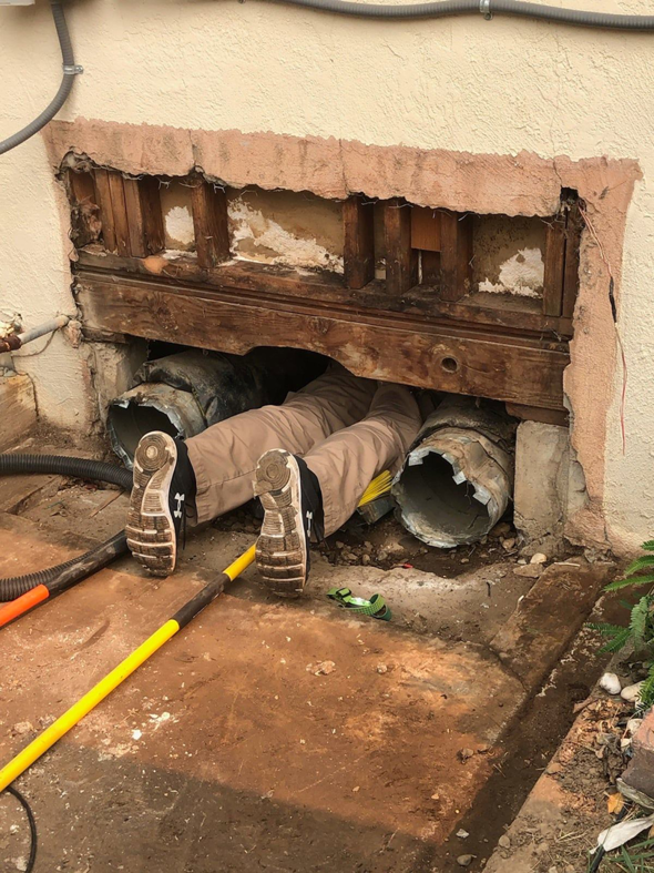 A technician performing ductwork repair in a crawl space for ALL YEAR Heating, Air and Solar in Sacramento, CA.