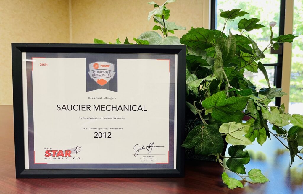 A Saucier Mechanical Services technician operating a sheet metal machine to fabricate ductwork in Plantsville, CT.
