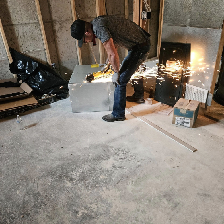 A technician grinding metal during an HVAC installation project for JL Mechanical in Pleasant Grove, UT.