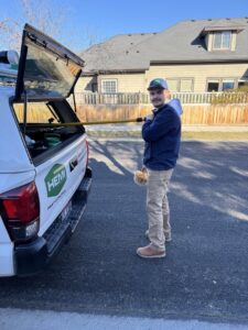 A Hemi Pest Control technician holding a trap with captured rodents, demonstrating effective wildlife control in Meridian, ID.