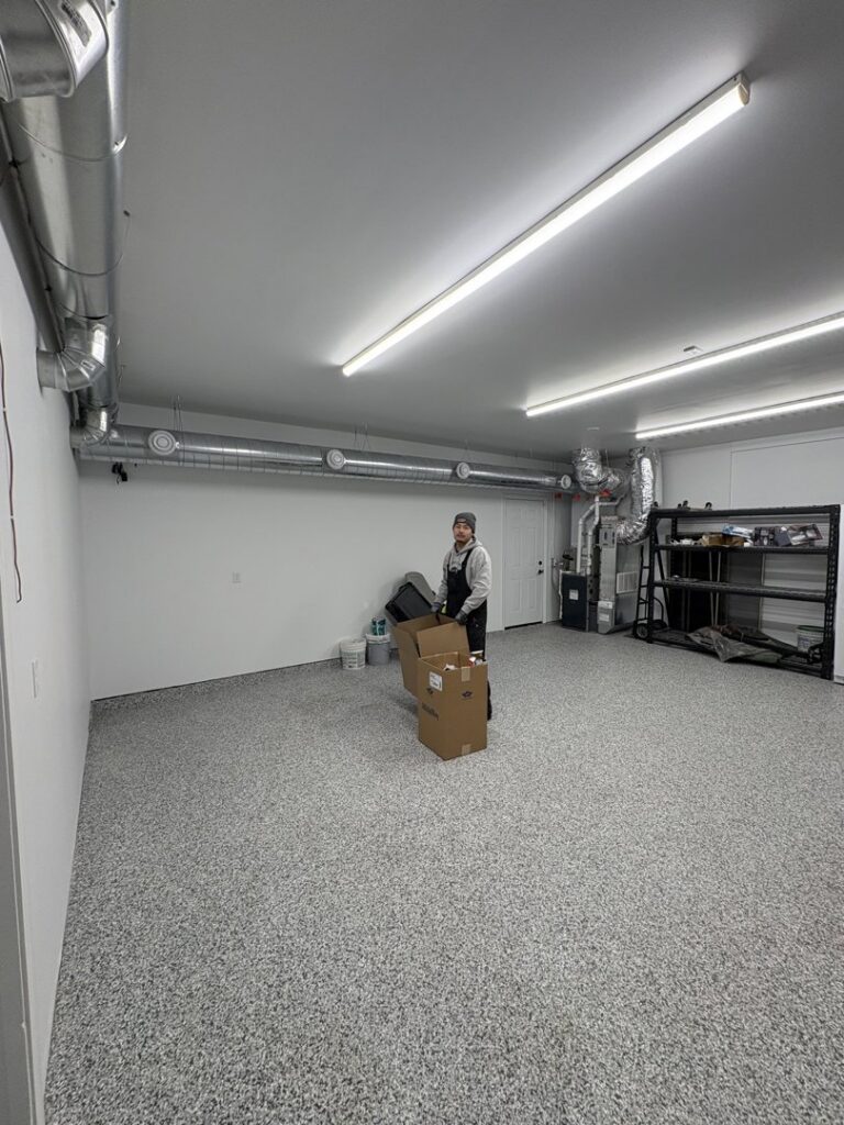 An A&E Heating & Cooling technician in a garage with newly installed HVAC ductwork in Fort Worth, TX.