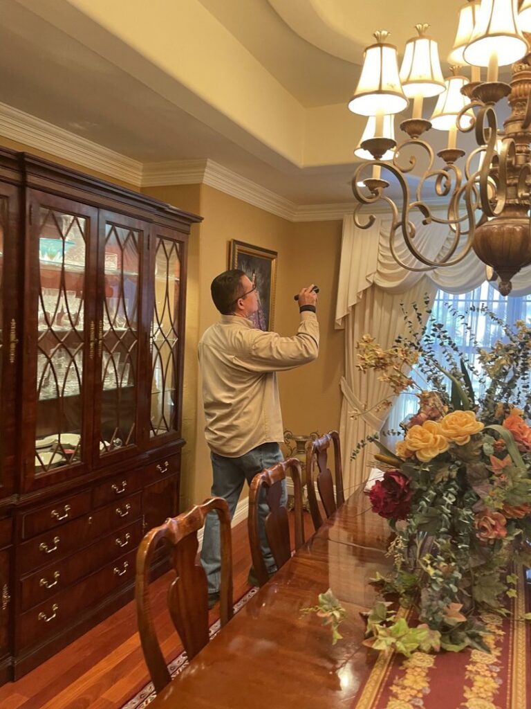 A Target Pest Control technician inspecting a home's interior for signs of pests in Manchester, CT.