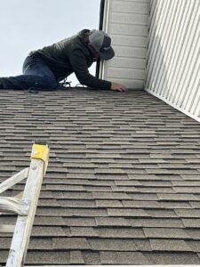 A pest control technician inspecting roof eaves for potential pest or wildlife entry points for The Pest Detective in Cleveland, OH.