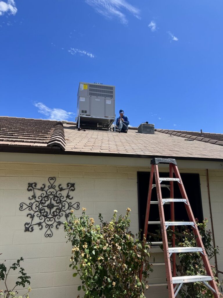 An Arrow Pro Services technician inspecting a newly installed rooftop HVAC unit on a residential home in Gilbert, AZ