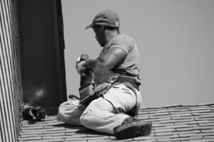 A technician installing a wildlife exclusion barrier or vent cover on a roof for Direct Pest Solutions Of Georgia, LLC in McDonough, GA.