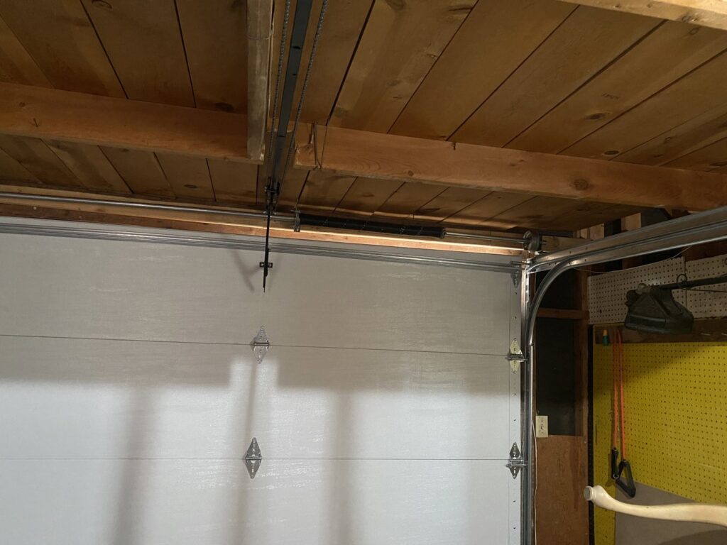 A technician from American Eagle Garage Doors installing a new garage door panel at a job site in Greeley, CO.