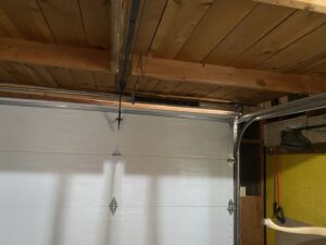 A technician from American Eagle Garage Doors installing a new garage door panel at a job site in Greeley, CO.