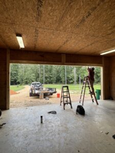 A technician installing a garage door track system for Specialty Garage Door in Bossier City, LA
