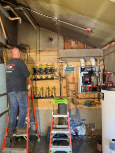 A Boudreau's Heating technician installing a new hydronic heating system in Vassalboro, ME.