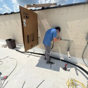 A technician installing mounting brackets for an HVAC unit on a rooftop by Southern Comfort Heating & Cooling in Lexington, KY