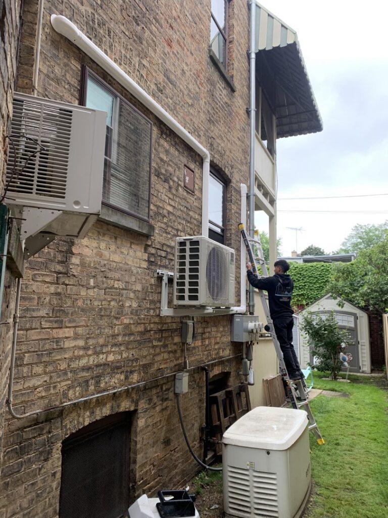 An Hvac Buddies technician installing outdoor mini-split air conditioning units in Chicago, IL