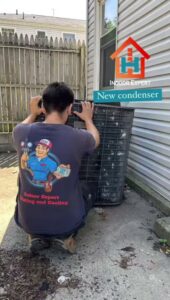 A technician from Indoor Expert Heating & Cooling installing a new outdoor air conditioning condenser unit in Paterson, NJ.