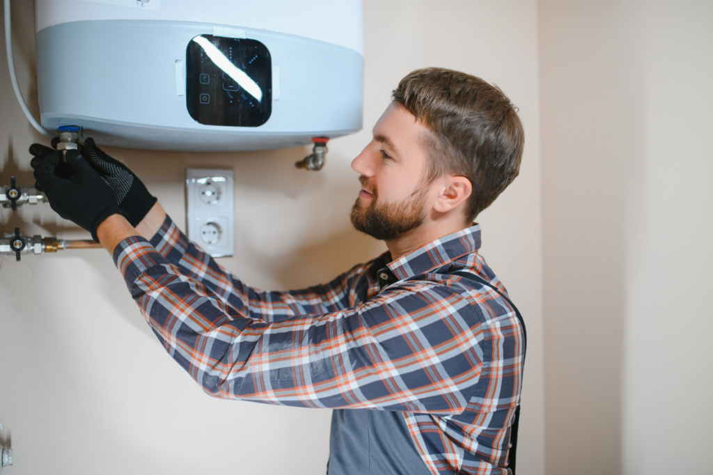 A technician installing a tankless water heater, a service provided by Comfy Cave Heating and Air Conditioning in Arvada, CO.