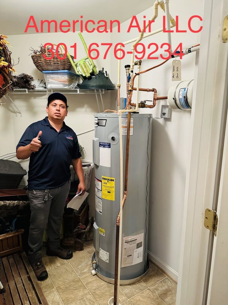 A technician from American Air LLC giving a thumbs up next to a newly installed water heater in Moncks Corner, SC