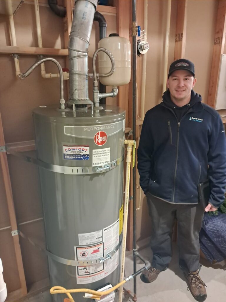 A Comfort Heating, Cooling & Electrical technician installing a new Rheem water heater in Post Falls, ID