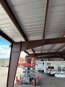 A Montana Pest Solutions technician on a scissor lift installing wildlife exclusion netting in Missoula, MT