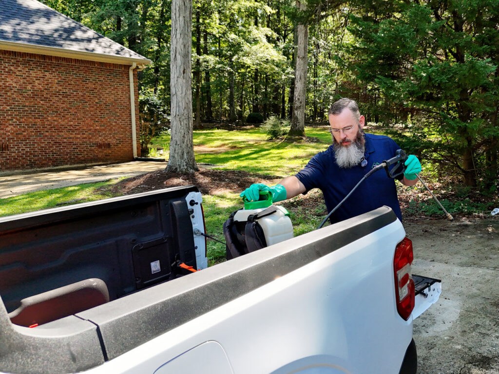 A Pest Magic Pest Control technician loading equipment into the back of a truck for a job in Forsyth, GA.