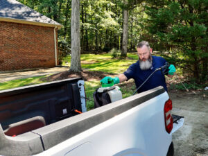 A Pest Magic Pest Control technician loading equipment into the back of a truck for a job in Forsyth, GA.