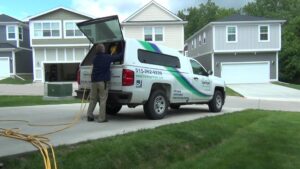 A technician loading equipment into a branded service truck for Springer Professional Home Services in Des Moines, IA.