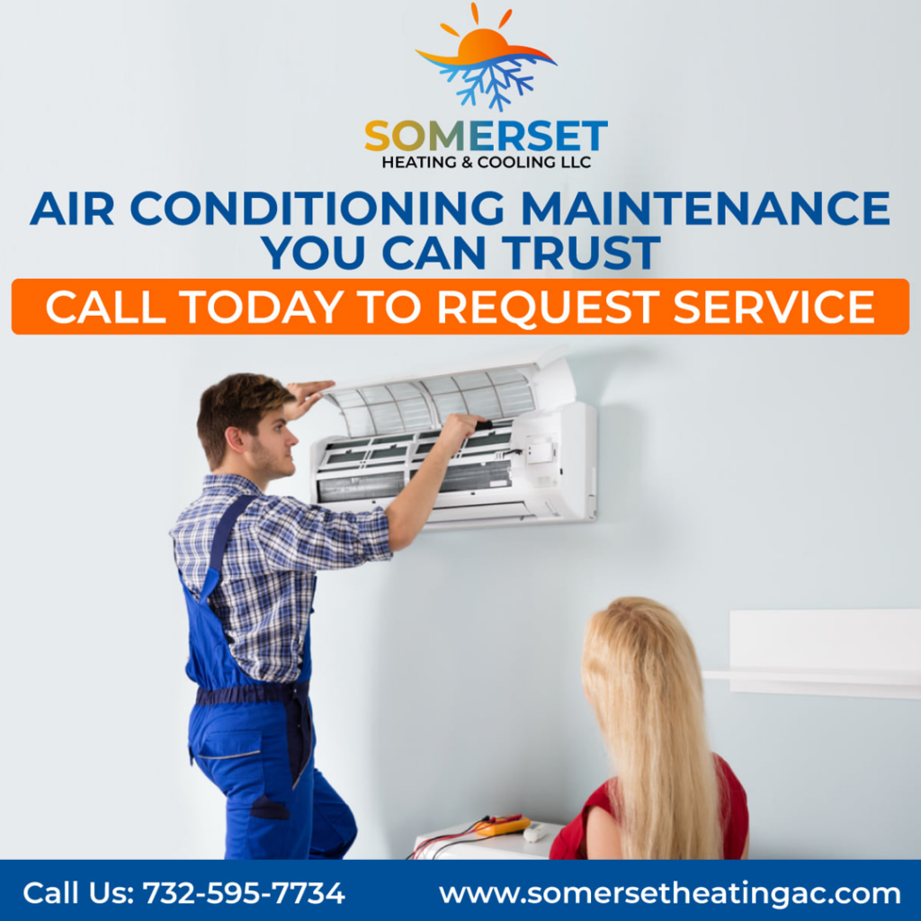 A technician performing air conditioning maintenance on an indoor unit for Somerset Heating & Cooling LLC in Somerset, NJ.