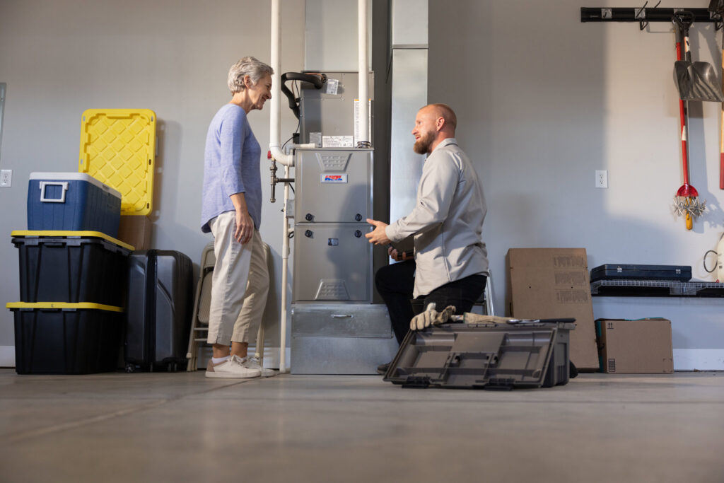 An S&B heating and cooling technician performing maintenance on an outdoor AC unit in Florence, KY.