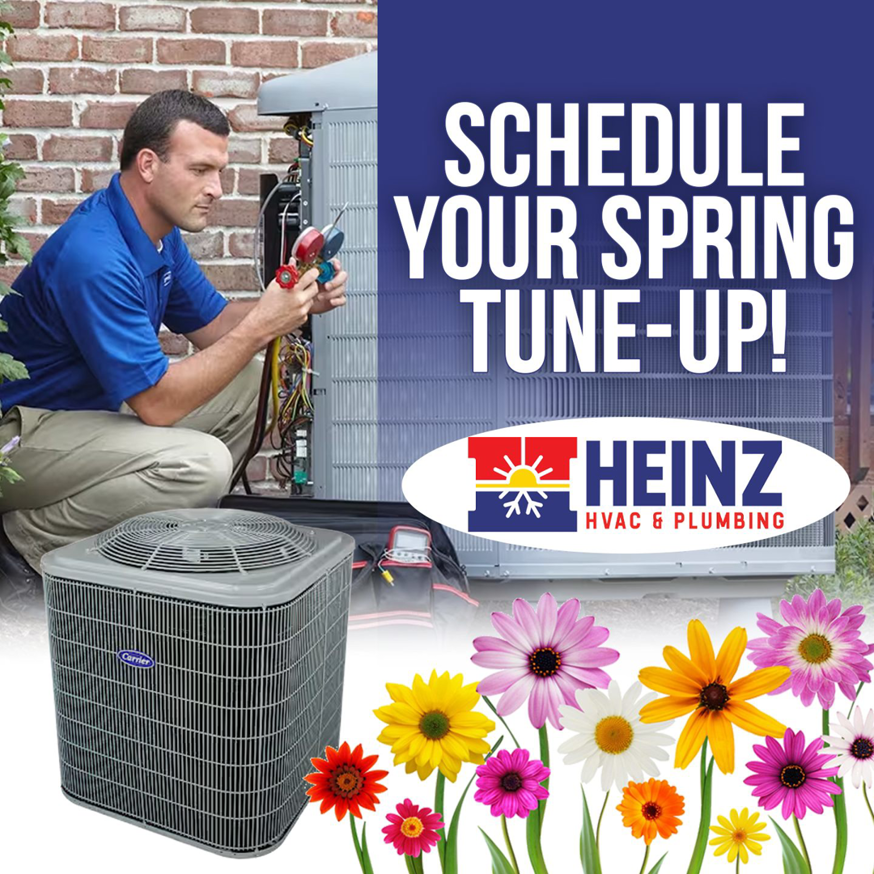 A technician performing a spring tune-up on an outdoor AC unit for Heinz HVAC & Plumbing in Vincennes, IN.