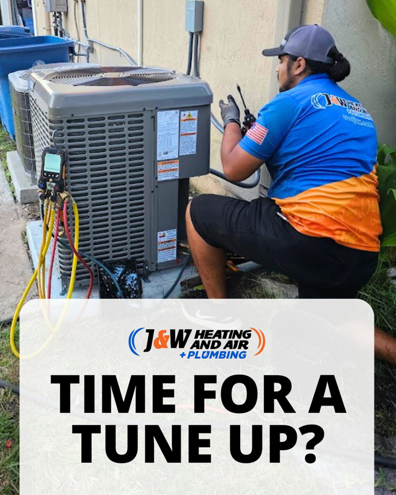 A technician performing an AC tune-up on an outdoor unit for J&W Heating and Air + Plumbing in Jacksonville, FL.